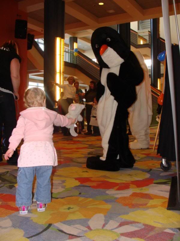 Giving penguin her kitty