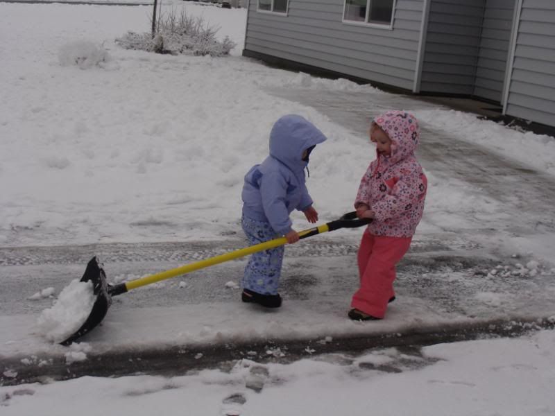 Both girls shoveling